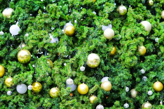 part of Christmas tree has green leaves and decorated with various items to celebrate Christmas festival