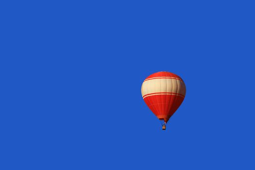 A red balloon floats on blue sky background in Vang Vieng, Laos
