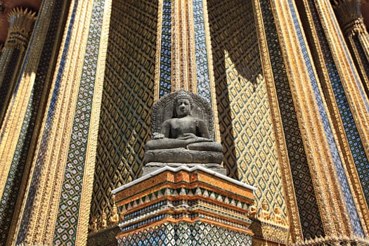 Black sitting Buddha made from volcanic lava rock In front of Royal Pantheon or Prasat Phra Thep Bidorn, Bangkok Thailand