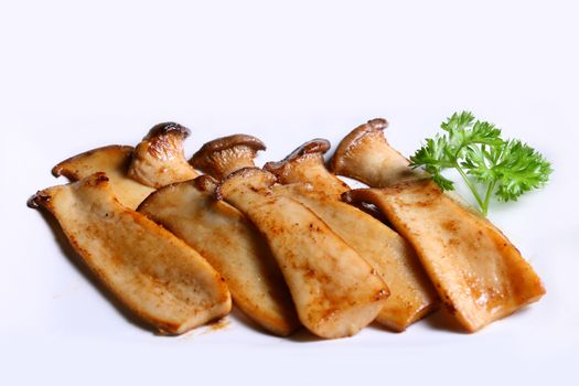 Grilled Abalone Mushroom flavored with salt and pepper on white background