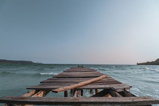 Conceptual photo of a broken wooden pier showing concept of the importance of supporting mental health, social isolation and social distancing during the covid-19 pandemic