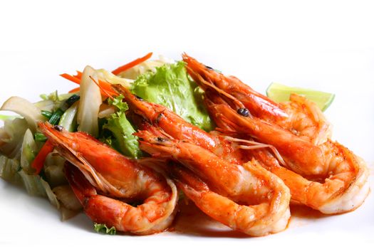 Grilled tiger shrimps with spice and lemon with fresh salad leaf in white background