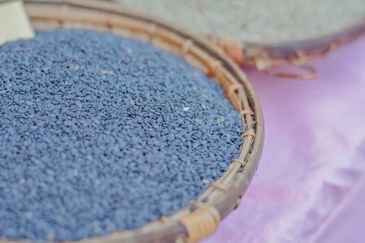 Group of black sesame seeds in bamboo basket sell at Thailand local market.