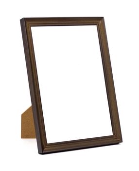 Vertical standing brown wooden picture frame isolated on white background with clipping path