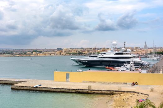 Luxury yachts moored in the port on Ortygia Islands in Syracuse, Sicily, Italy