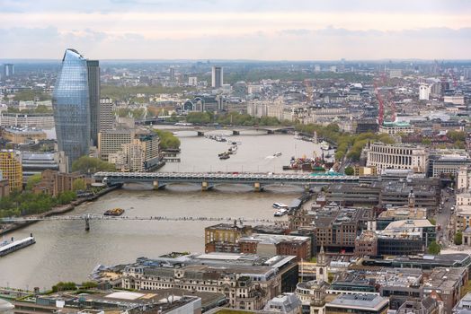 Aerial view of Thames river in London on a cloudy day