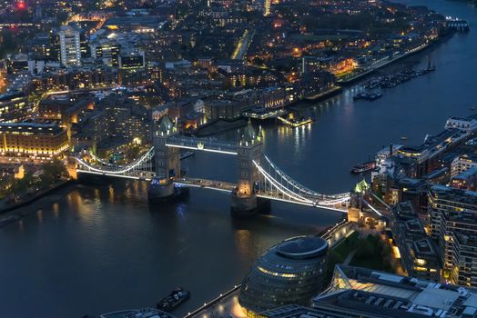 Aerial view of Tower Bridge in London at an overcast day at night