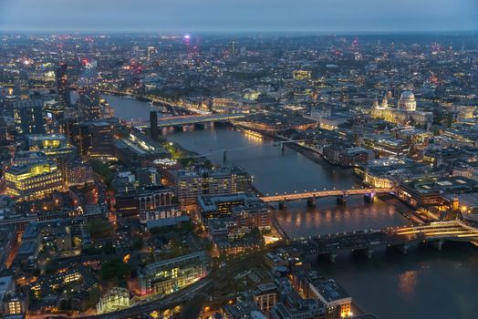Aerial view of river Thames in London on a cloudy day at dusk