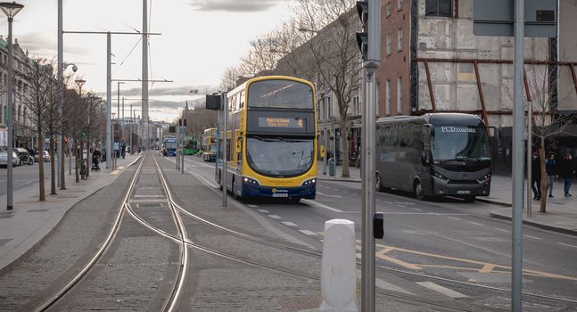 Dublin, Ireland - February 12, 2019: Typical Irish double decker bus running with its passengers in the city center on a winter day