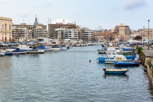 Boats moored in small sea port in Syracuse, Sicily, Italy