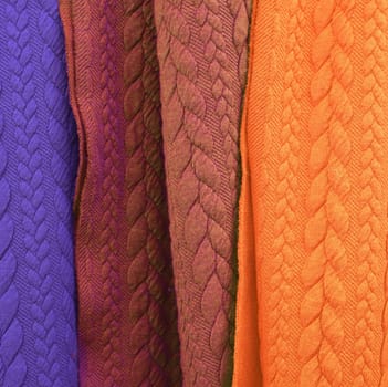 Detailed close up view on samples of cloth and fabrics in different colors found at a fabrics market.