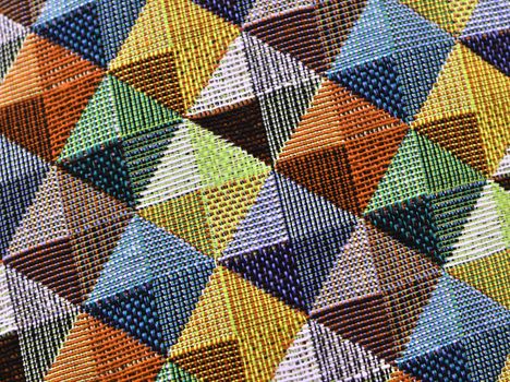 Detailed close up view on samples of cloth and fabrics in different colors found at a fabrics market.