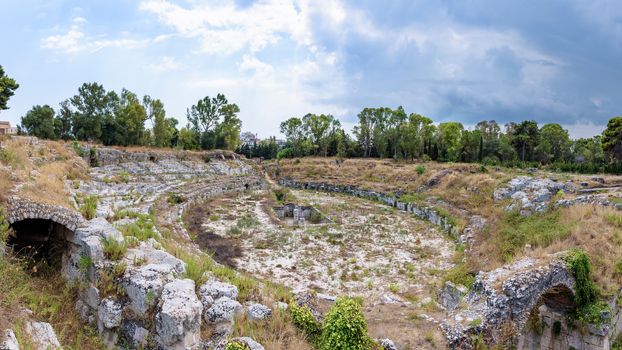 Panoramic view of ruins of the ancient roman Amphitheatre in Syracuse (Anfiteatro romano di Siracusa), Sicily, Italy