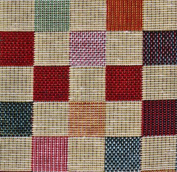 Detailed close up view on samples of cloth and fabrics in different colors found at a fabrics market.