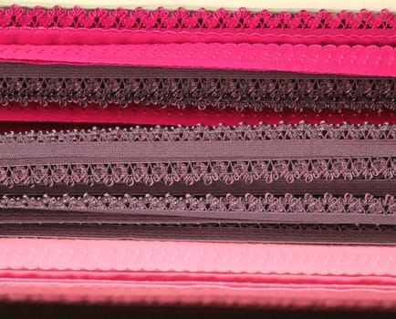 Detailed close up view on samples of cloth and fabrics in different colors found at a fabrics market.