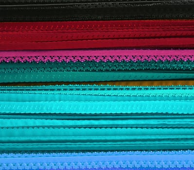 Detailed close up view on samples of cloth and fabrics in different colors found at a fabrics market.