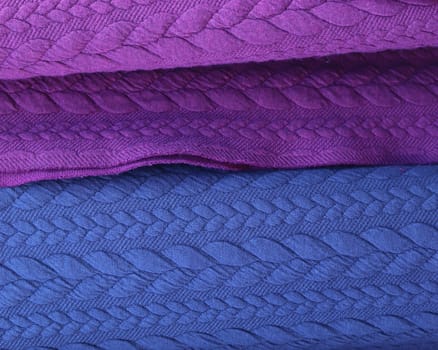 Detailed close up view on samples of cloth and fabrics in different colors found at a fabrics market.