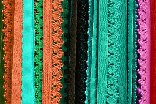 Detailed close up view on samples of cloth and fabrics in different colors found at a fabrics market.