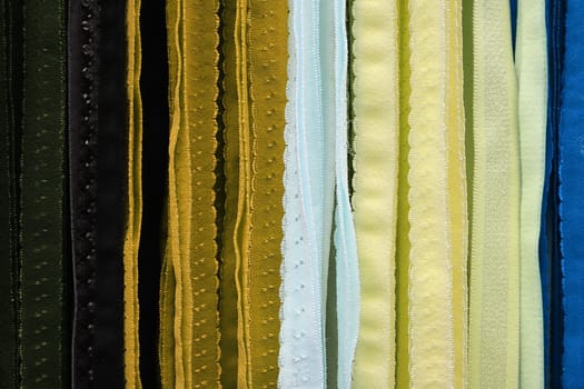 Detailed close up view on samples of cloth and fabrics in different colors found at a fabrics market.