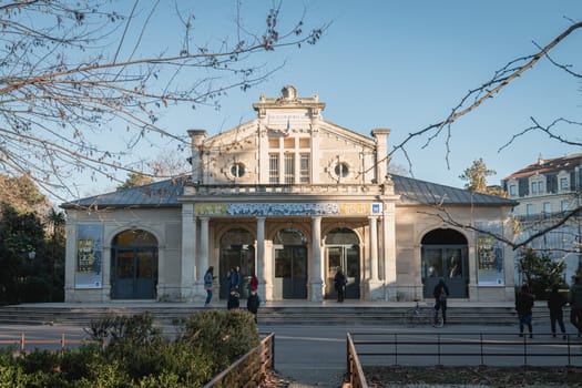 Montpellier, France - January 2, 2019: architectural detail of the popular pavilion (Pavillon Populaire) next to the Place de la Comedie where people pass on a winter day