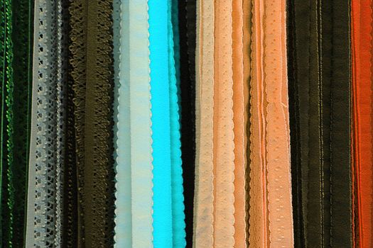 Detailed close up view on samples of cloth and fabrics in different colors found at a fabrics market.