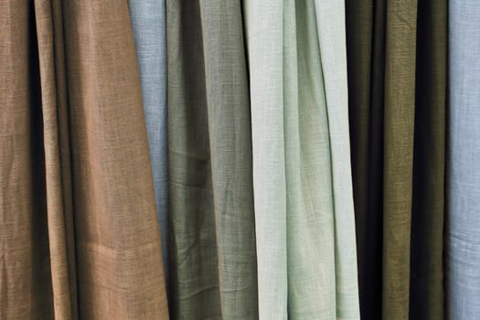 Detailed close up view on samples of cloth and fabrics in different colors found at a fabrics market.