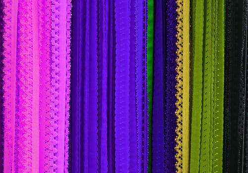 Detailed close up view on samples of cloth and fabrics in different colors found at a fabrics market.