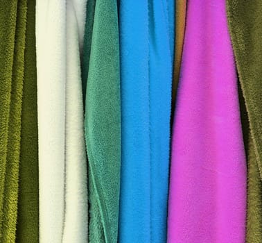 Detailed close up view on samples of cloth and fabrics in different colors found at a fabrics market.