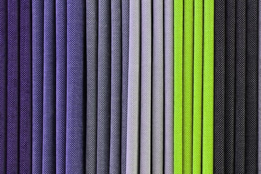 Detailed close up view on samples of cloth and fabrics in different colors found at a fabrics market.