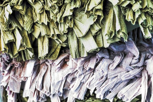 Detailed close up view on samples of cloth and fabrics in different colors found at a fabrics market.