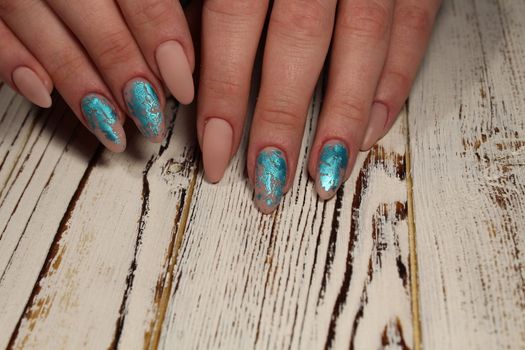 Hands with long artificial manicured nails colored with red nail polish