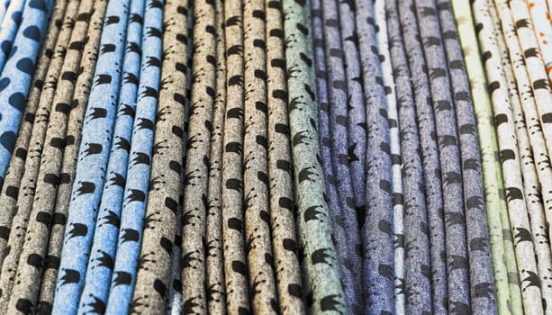 Detailed close up view on samples of cloth and fabrics in different colors found at a fabrics market.