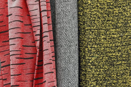 Detailed close up view on samples of cloth and fabrics in different colors found at a fabrics market.