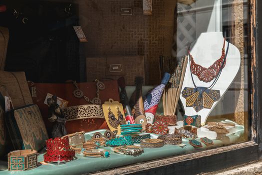 Obidos, Portugal - April 12, 2019: View of the window of a souvenir shop on a spring day with its reproductions of objects and clothing accessories formerly worn in historic city