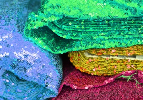 Detailed close up view on samples of cloth and fabrics in different colors found at a fabrics market.