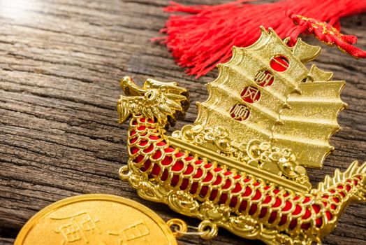 chinese style of decoration mobile with the chinese word mean "Propitious wind throughout the journey (idiom)" on sail and "Financial Resources brings Vast Incomes" on the coin