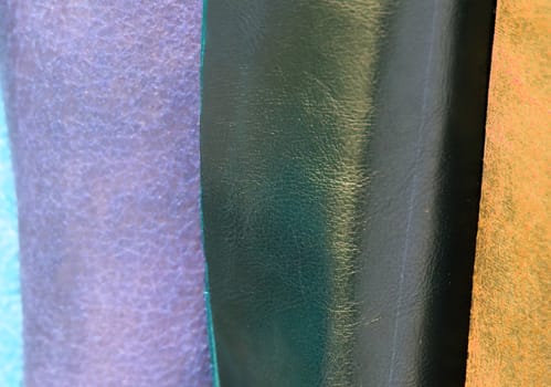 Detailed close up view on samples of cloth and fabrics in different colors found at a fabrics market.