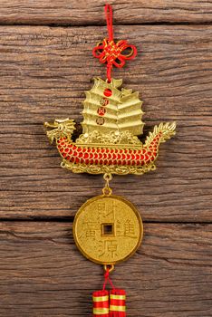 chinese style of decoration mobile with the chinese word mean "Propitious wind throughout the journey (idiom)" on sail and "Financial Resources brings Vast Incomes" on the coin