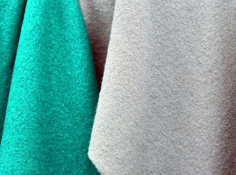 Detailed close up view on samples of cloth and fabrics in different colors found at a fabrics market.