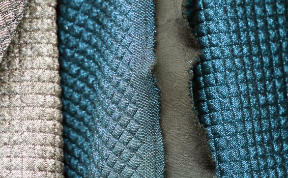 Detailed close up view on samples of cloth and fabrics in different colors found at a fabrics market.