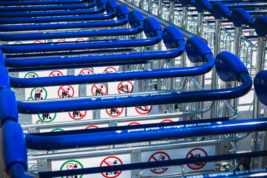 Faro, Portugal - May 3, 2018: carry cart outside Faro international airport available to travelers to move their luggage on a spring day