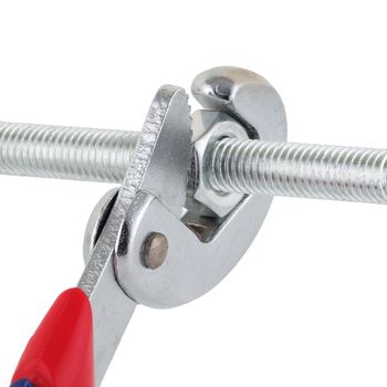 An adjustable wrench spanner tightening a nut on a bolt