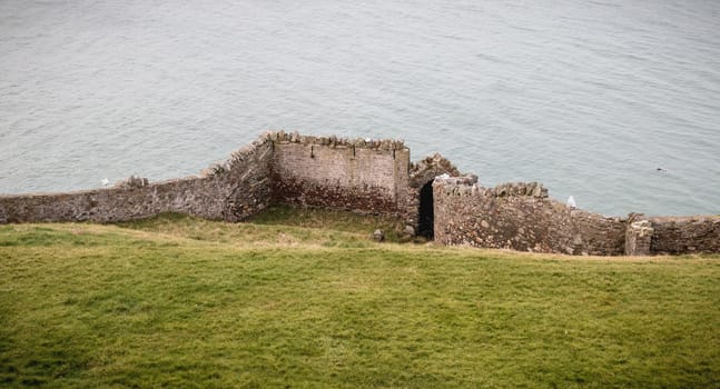 old stone wall in front of the sea in Ireland