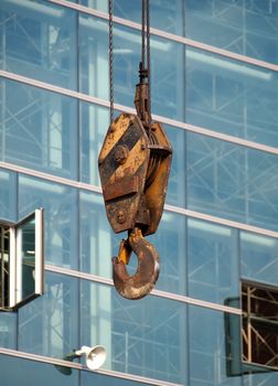 A large hook of a crane at a constuction site
