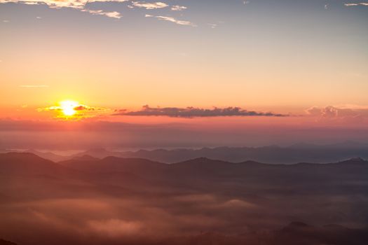 Scenic view of beautiful sunrise and mist over the mountains