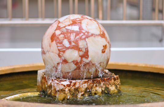 Large round shaped stones are spinning on a stone platform. And there is water flowing all the time