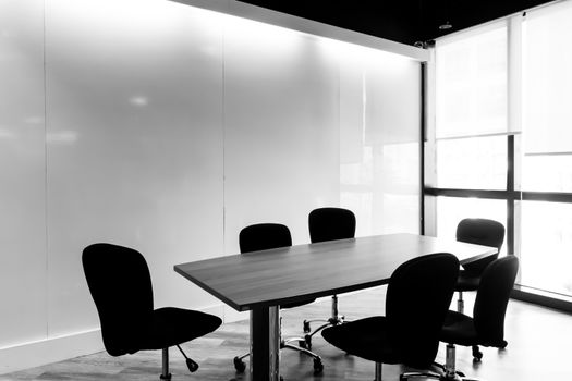 Table and chairs in a  conference room.black and white tone.