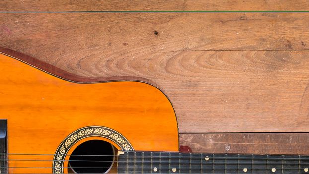 Top view workspace with acoustic guitar on wooden table background .Free space for your text.