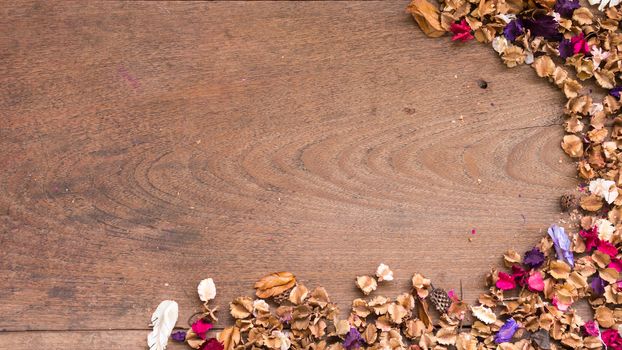 Top view workspace with dried flowers on wooden table background .Free space for your text.