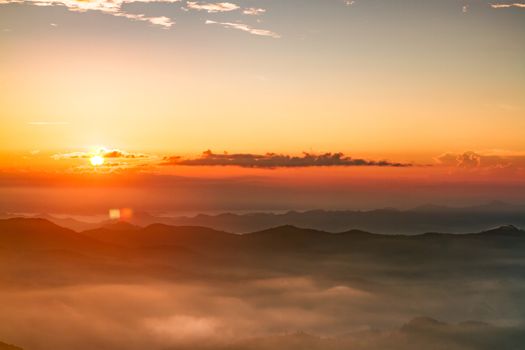 Scenic view of beautiful sunrise and mist over the mountains